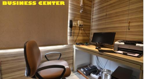 an office with a desk with a computer and a printer at Hotel Annapoorna Residency in Hyderabad