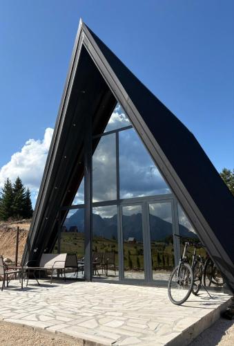 a building with a roof with bikes parked in front at Vista Montis in Žabljak