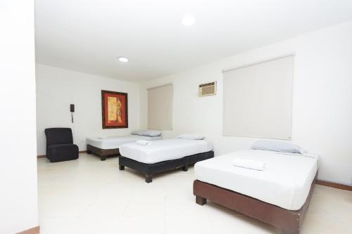 Ένα ή περισσότερα κρεβάτια σε δωμάτιο στο Hotel Villa Real