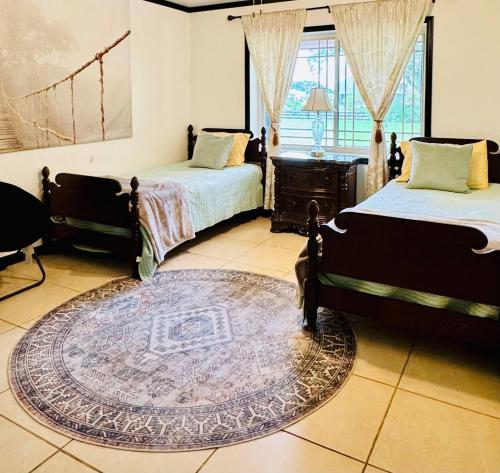 a bedroom with two beds and a rug at Luxury Home -Sleeps 8- Pet OK- St. Cloud - Orlando in Saint Cloud