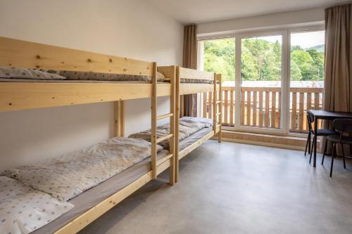 two bunk beds in a room with a balcony at The Cabin Retreat Piešťany 