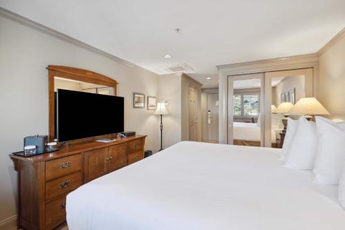 a bedroom with a large bed and a flat screen tv at Lodge Tower 482 in Vail