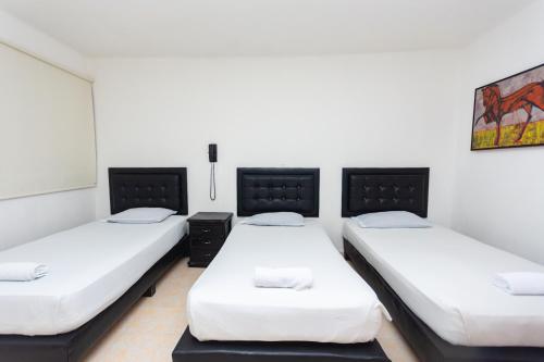 Ένα ή περισσότερα κρεβάτια σε δωμάτιο στο Hotel Villa Real