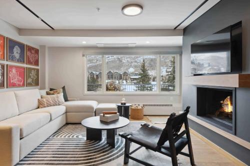 a living room with a couch and a fireplace at Lodge Tower 486 Two Bedroom Residence in Vail