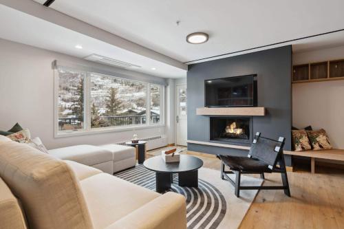 a living room with a couch and a fireplace at Lodge Tower 486 Two Bedroom Residence in Vail