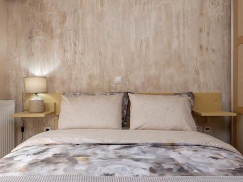 a bedroom with a large bed with two night stands at Cozy City Center apartment in Xanthi