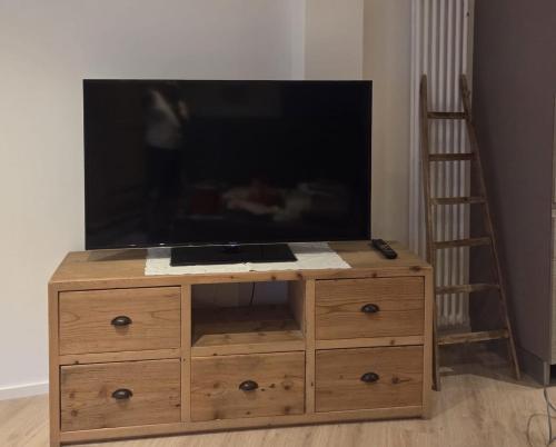 a wooden dresser with a flat screen tv on top at Leonard Chalet House in Albiano