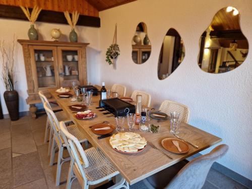 a dining room with a wooden table and chairs at Chalet typique proche Crans Montana in Icogne