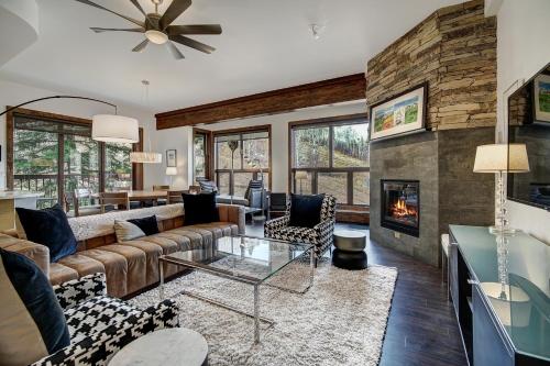 a living room with a couch and a fireplace at Osprey 303 in Beaver Creek