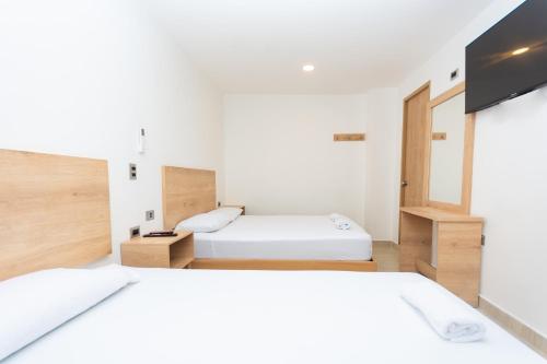 Ένα ή περισσότερα κρεβάτια σε δωμάτιο στο Hotel Villa Real