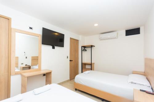 Ένα ή περισσότερα κρεβάτια σε δωμάτιο στο Hotel Villa Real