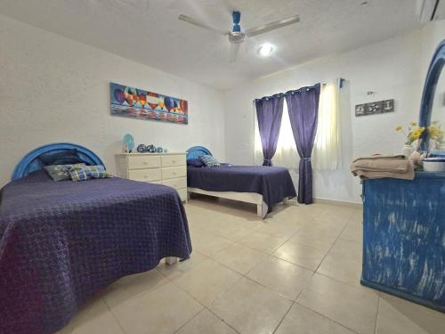 Katil atau katil-katil dalam bilik di Villa Santorini, Campeche