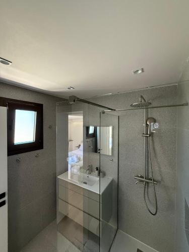 a bathroom with a shower and a sink at Petrochori Beach House in Voidokilia