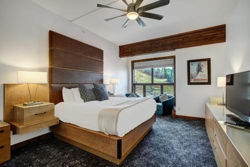 a bedroom with a bed and a flat screen tv at Osprey 303 in Beaver Creek