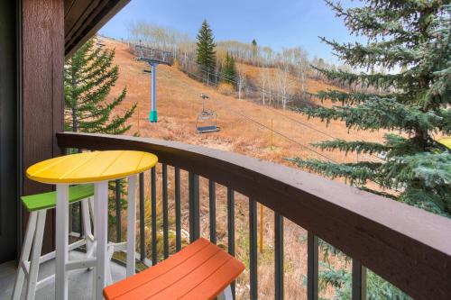 a balcony with a table and chairs and a ski lift at Osprey 303 in Beaver Creek