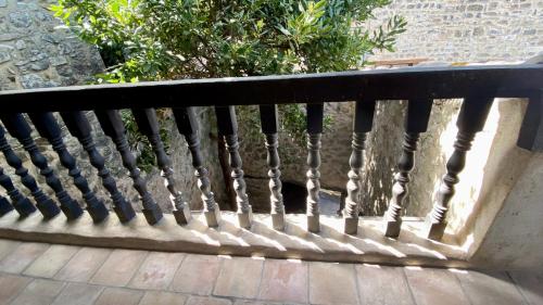 a black bench sitting on a patio at La Mistraline, 2 bedrm 2 bath house in the heart of Provence in Caseneuve
