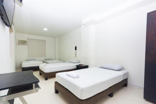 Ένα ή περισσότερα κρεβάτια σε δωμάτιο στο Hotel Villa Real