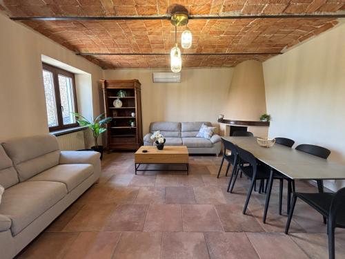 a living room with a couch and a table at Relais Portaluna delle Langhe in Mango
