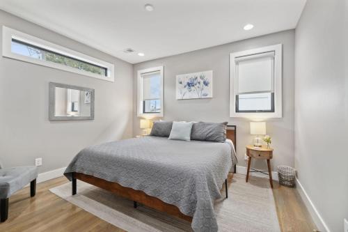 a bedroom with a bed and two windows at 2mi Downtown Hot Tub Balcony 4 King Beds in Nashville