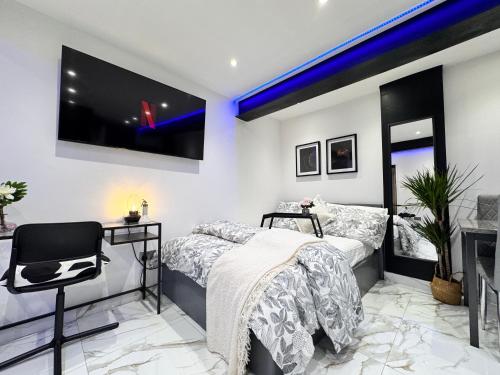 a bedroom with two beds and a flat screen tv at Gorgeous Holiday Home 5 minutes from Central London in London