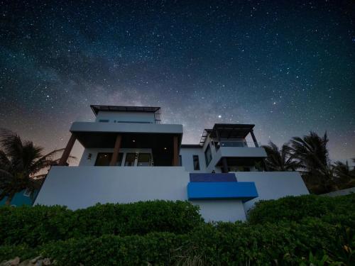 a house at night with a starry sky at Eagle Ray - A Luxurious Waterfront Villa, in Gibson Bight