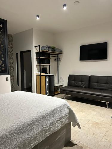 a living room with a bed and a couch at Habitación 4 in Rosarito Beach