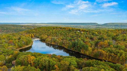 an aerial view of a river in the fall at Stylish Mountain Retreat w Hot Tub Firepit Penn Estate Getaway by AvantStay in East Stroudsburg