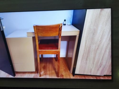 einen Schreibtisch mit einem Stuhl, der an einem Schreibtisch sitzt in der Unterkunft Forrad Suite & Apartment Gwarinpa in Gwarinpa