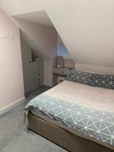 a bedroom with a bed in an attic at Henlow Annexe Room 1 in Henlow
