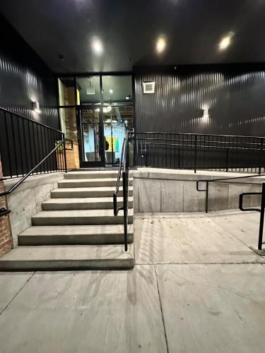 a set of stairs in a building with a stair railing at River North Rooftop With In and Out Parking 1 in Chicago