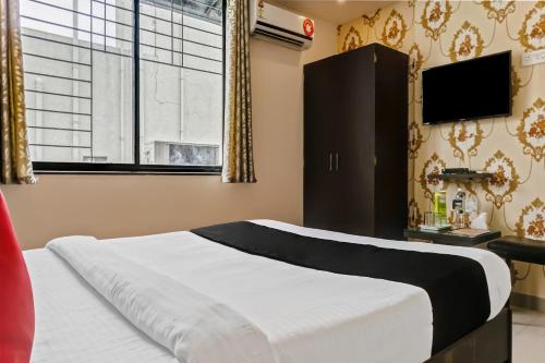 Μια τηλεόραση ή/και κέντρο ψυχαγωγίας στο Hotel O Log Inn Plaza