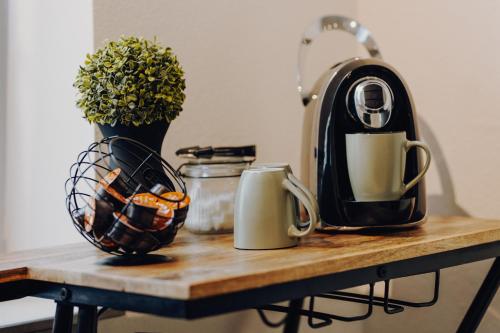 a table with a coffee maker and cups on it at Charmanter Altbau in City Nähe in Osnabrück