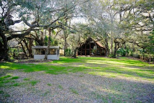 a house with a gazebo in a yard with trees at The Nature House in Hernando