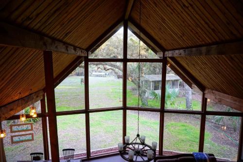 a view from the inside of a room with windows at The Nature House in Hernando