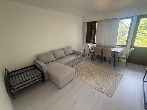 a living room with a couch and a table at Apartment in a quiet location check in 247 in Kemi