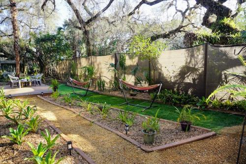 a garden with two hammocks and plants at The Nature House in Hernando