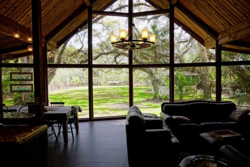 a living room with couches and a chandelier at The Nature House in Hernando