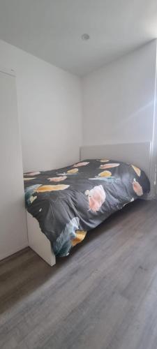 a bedroom with a bed with a blanket on it at CitySpot 159 in Brussels