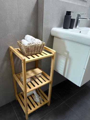 a bathroom with a towel rack next to a sink at Central Terrace Apartment in Nové Zámky