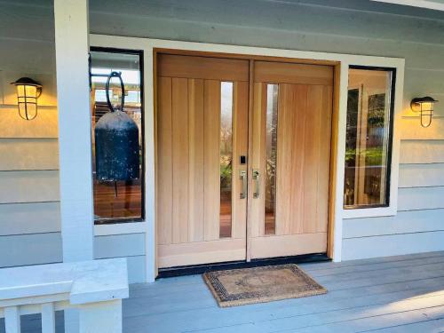 a front door of a house with a vase at Luxury Waterfront & Views, Private Beach, Golfing in Eastsound