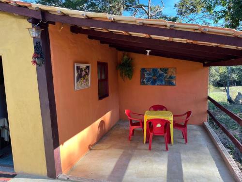 a table and chairs on the porch of a house at Chalé Inhambu Tiradentes in Tiradentes
