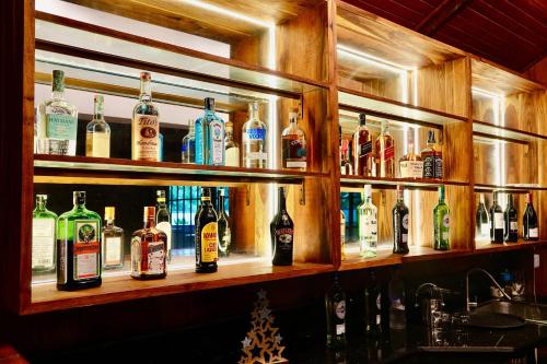 a shelf filled with lots of bottles of alcohol at Green Hills Lodge in Usa River