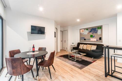 a living room with a table and chairs and a couch at Insurgentes APT Private Balcony, Roof Lounge in Mexico City