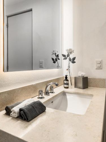 a bathroom with a sink and a mirror at Insurgentes APT Private Balcony, Roof Lounge in Mexico City