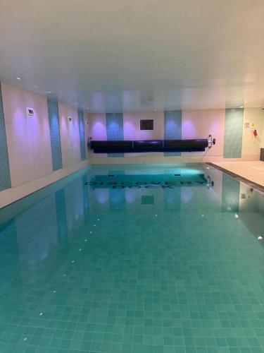 a large swimming pool with at Canary Wharf-WOMEN Only-Private Double Room & Pool Gym in London