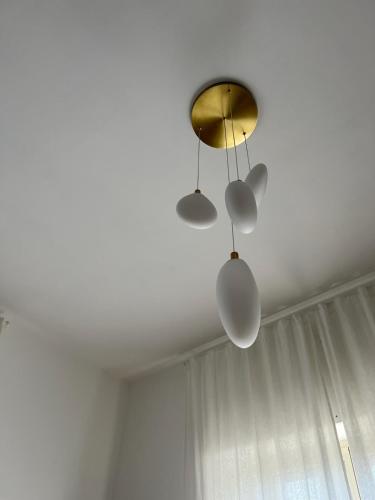a ceiling fan with three lights on a ceiling at Dionisio 7 in Pescara