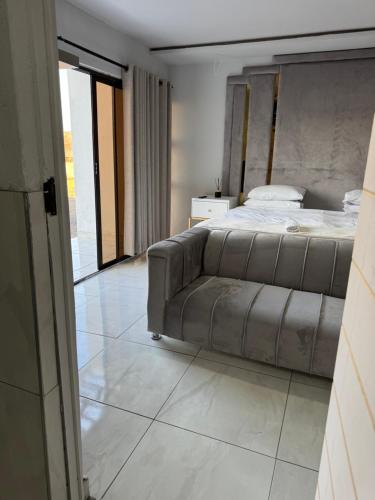 a bedroom with a bed and a couch at RCB guesthouse in Burgersfort