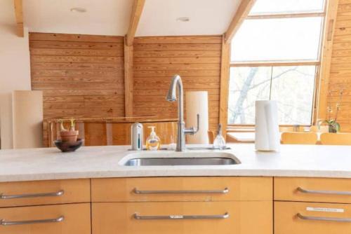 a kitchen with a sink and a window at Dome Compound with Hot Tub, Piano and Rock-Climbing Gym in New Paltz