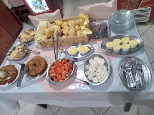 a table topped with lots of different types of food at Pousada Casa Grande in São Lourenço