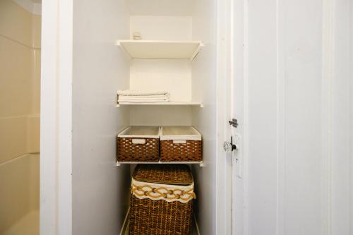 a walk in closet with three baskets in it at Charming Basement Suite with Private Entrance Near Subway, Koreatown & UofT in Toronto